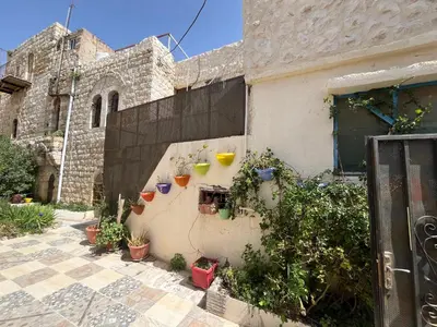 a building with potted plants on the side of it at Al Karak House in Kerak