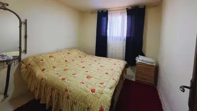 a bedroom with a bed and a dresser and a window at Al Karak House in Kerak
