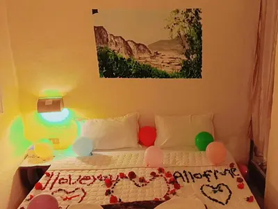 a bedroom with a bed with balloons on it at Dana Sunset Village Hotel in Dana