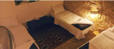 a view of a bedroom with a bed at Dana Sunset Village Hotel in Dana