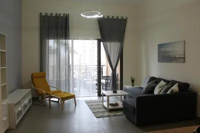 a living room with a couch and a chair at Samarah Dead Sea Resort Apartment with Sea View FP4 Traveler Award 2025 Winner Thursday, Friday & Saturday Groups consisting solely of male guests are not permitted in Sowayma