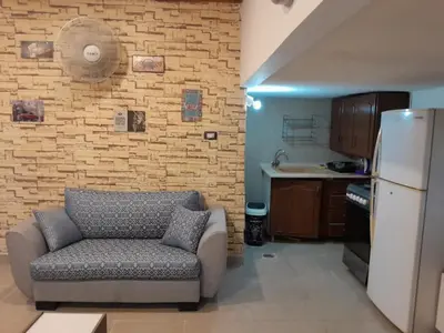 a living room with a couch and a brick wall at MK2 - One Bedroom Apartment in Amman