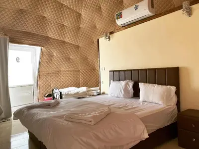 a bedroom with a large bed with white pillows at Wadi Rum The ARC camp in Wadi Rum