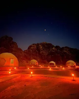 a group of tents in the desert at night at Wadi Rum The ARC camp in Wadi Rum