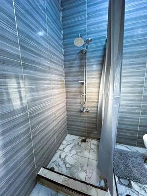a bathroom with a shower with a sink at Jerash City View in Jerash