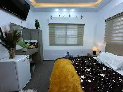 a bedroom with a bed with a black and white blanket at Jerash City View in Jerash