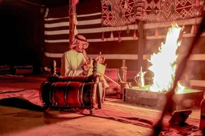 a statue of a man sitting next to a fire at Echo Desert Camp in Wadi Rum