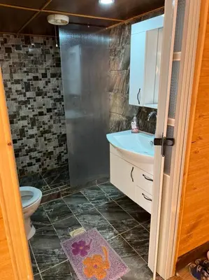 a bathroom with a shower and a sink and a toilet at Echo Desert Camp in Wadi Rum