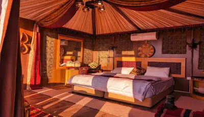 a bedroom with a bed in a tent at Wadi Rum Majestic Camp in Wadi Rum