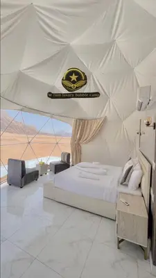 a bedroom with a bed in a tent at RUM W BUBBLE lUXURY CAMP in Wadi Rum