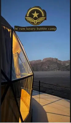 a glass building with the nyu firm luxury building complex at RUM W BUBBLE lUXURY CAMP in Wadi Rum