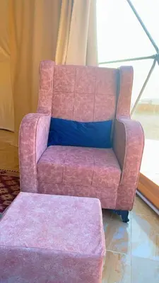 a pink couch sitting in a living room at Panorama bubble camp in Disah