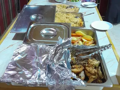 a table with several trays of food on it at Panorama bubble camp in Disah