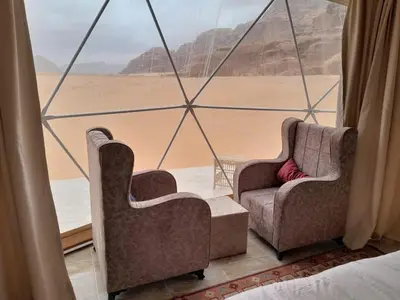 two chairs in a room with a view of the desert at Panorama bubble camp in Disah