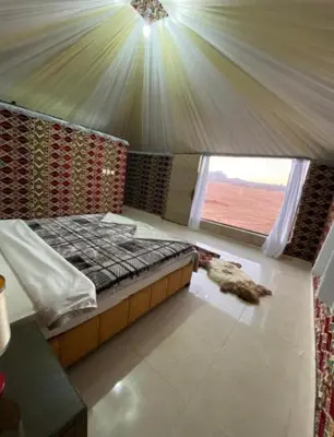 a bedroom with a bed in a tent at Wadi Rum Gulf camp in Aqaba