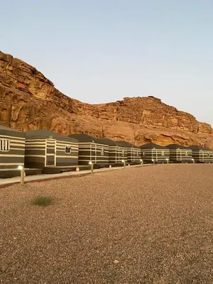 a train parked in front of a mountain at Wadi Rum Gulf camp in Aqaba