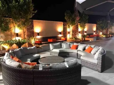 a patio with couches and a table and a fire pit at Taj Villa 1 deadsea - Entire Villa with sea view in Sowayma