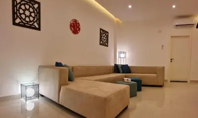 a living room with a couch and a table at Byblos Deluxe in Aqaba