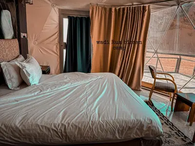 a bedroom with a bed in a tent at wadi Rum bissan camp in Wadi Rum