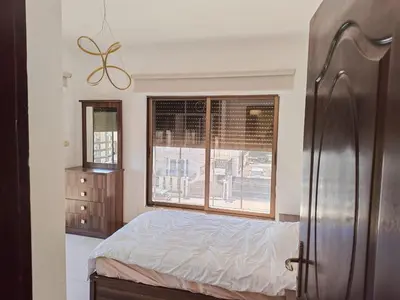 a bedroom with a bed and a window at Furnished apartment for rent In Abdoun شقة مفروشة للايجار في عبدون in Amman