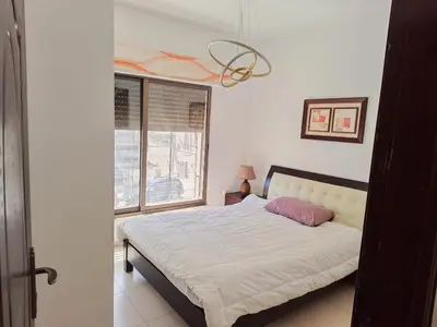 a bedroom with a bed and a window at Furnished apartment for rent In Abdoun شقة مفروشة للايجار في عبدون in Amman