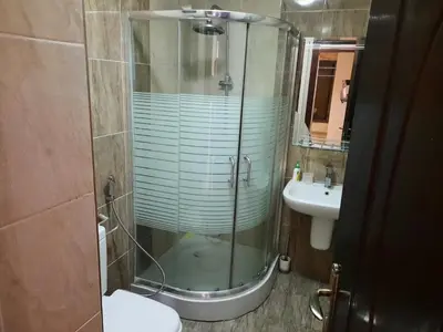 a bathroom with a glass shower and a sink at Furnished apartment for rent In Abdoun شقة مفروشة للايجار في عبدون in Amman