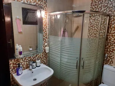 a bathroom with a glass shower and a sink at Furnished apartment for rent In Abdoun شقة مفروشة للايجار في عبدون in Amman