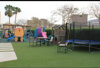 a park with a playground with chairs and slides at Dead Sea view Elite apartment Samara Resort traveler award 2024 in Sowayma