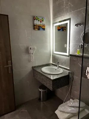 a bathroom with a sink and a mirror at Sky Hotel in Aqaba