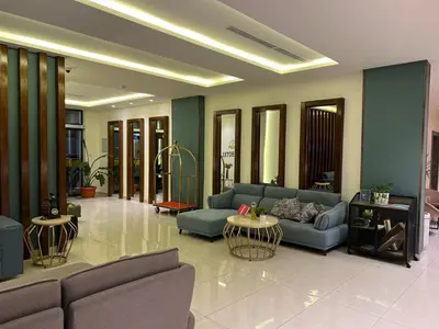 a living room with blue couches and tables at Sky Hotel in Aqaba
