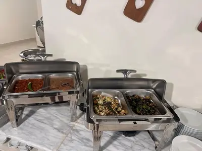 two trays of food sitting on a table at Sky Hotel in Aqaba