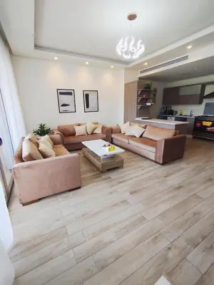 a living room with two couches and a table at Bridge apartments in Amman