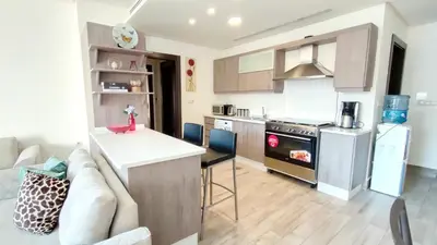 a kitchen with a couch and a table in a room at Bridge apartments in Amman