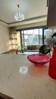 a room with a red plate on a table at Bridge apartments in Amman
